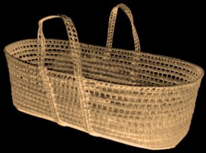 Image of a long oval wicker basket with looped carrying handles.