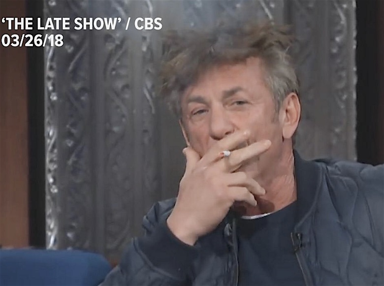 Promotional color photograph from CBS shows a frontal head and shoulders portrait of Sean Penn, ostensibly inhaling from a cigarette, with a haze above his head. Text superimposed over the image reads, The Late Show / CBS 03/26/18