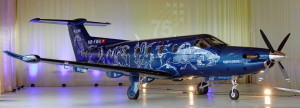 Color picture of the entire starboard side of the plane adorned by Hans Erni's drawings
